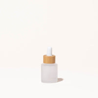 Simply Zero Forever Dropper Bottle in frosted glass with bamboo cap, .7 oz, on a cream background