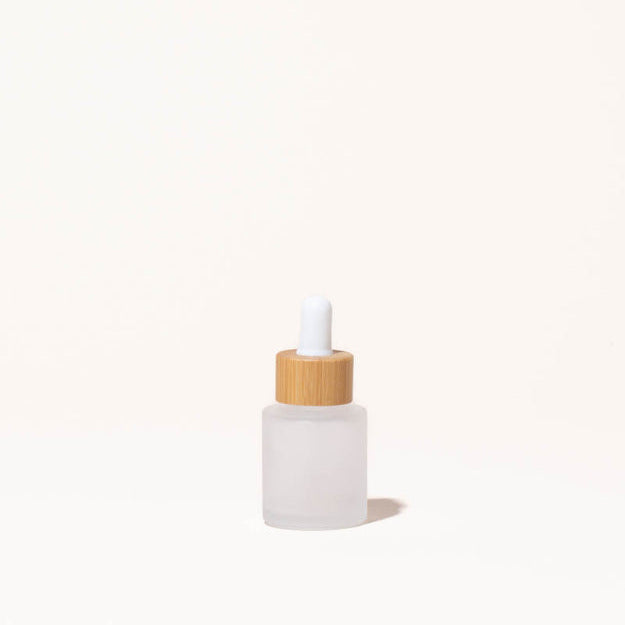 Simply Zero Forever Dropper Bottle in frosted glass with bamboo cap, .7 oz, on a cream background