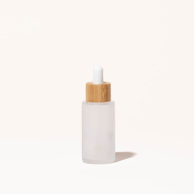 Simply Zero Forever Dropper Bottle in frosted glass with bamboo cap, 1.3 oz, on a cream background