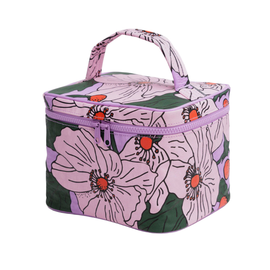 Floral-patterned makeup bag with a purple handle on a light gray background